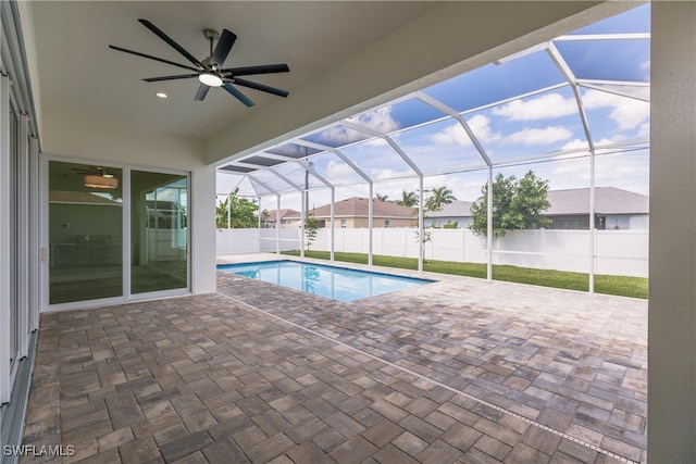 view of pool with a lanai, ceiling fan, and a patio area