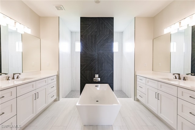 bathroom featuring vanity, independent shower and bath, and tile walls