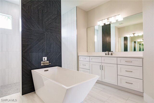 bathroom featuring tile walls, separate shower and tub, and vanity