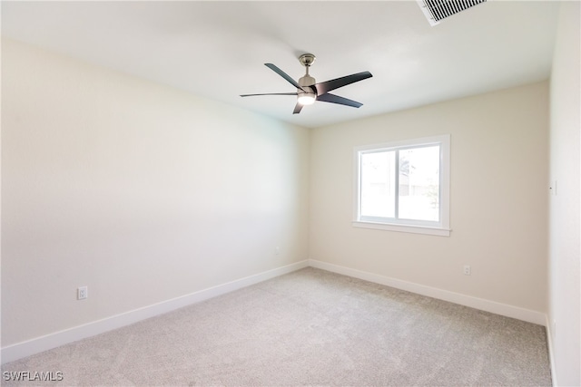 carpeted spare room with ceiling fan