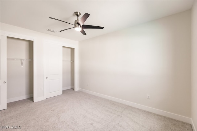 unfurnished bedroom featuring ceiling fan and light carpet