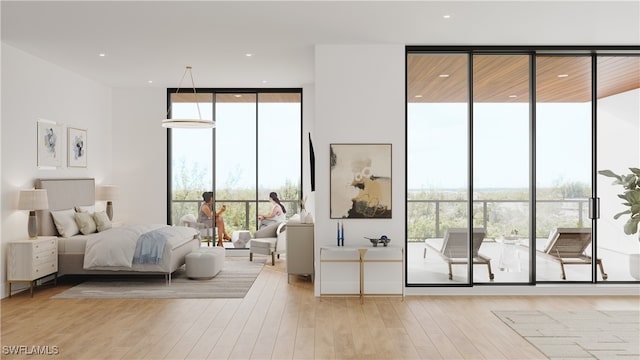 bedroom with multiple windows, a wall of windows, and light wood-type flooring