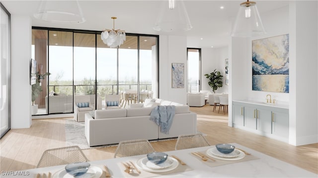 living room with a notable chandelier, light hardwood / wood-style floors, and floor to ceiling windows