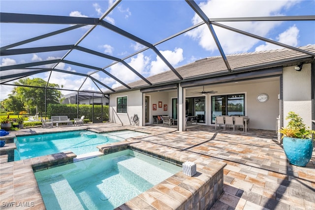 view of swimming pool featuring a patio, ceiling fan, an in ground hot tub, and a lanai