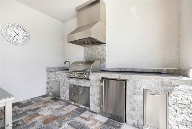 view of patio / terrace featuring a grill and an outdoor kitchen