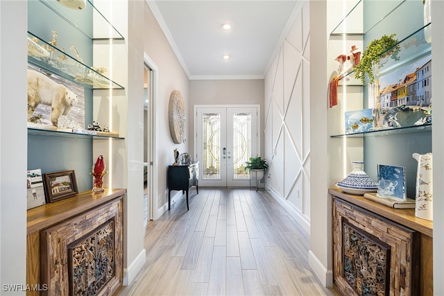 entrance foyer featuring light wood-type flooring, crown molding, and french doors