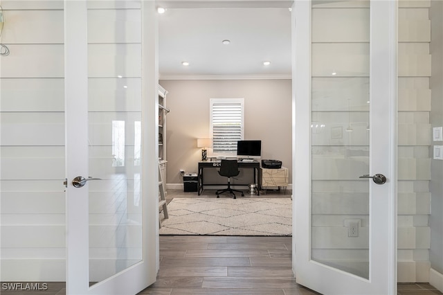 office with hardwood / wood-style floors and crown molding