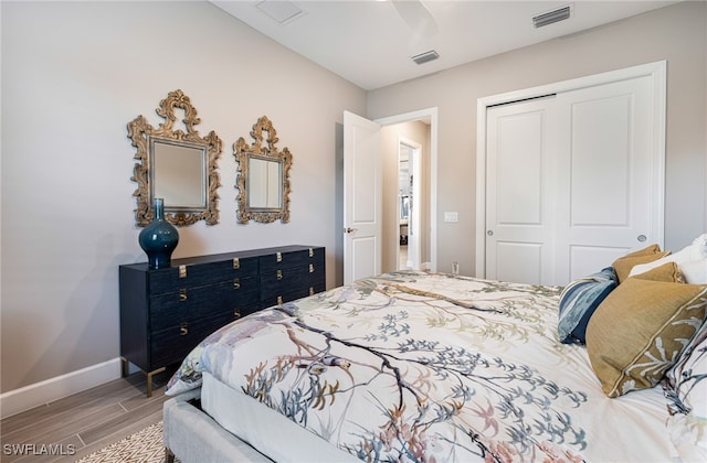 bedroom with wood-type flooring, a closet, and ceiling fan