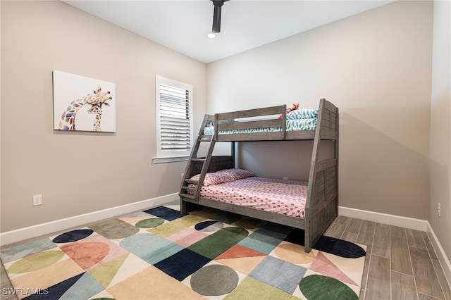 bedroom with ceiling fan and hardwood / wood-style flooring