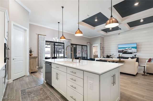 kitchen with a kitchen island with sink, sink, decorative light fixtures, white cabinetry, and stainless steel appliances