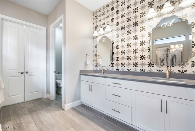 bathroom featuring hardwood / wood-style floors, vanity, and toilet