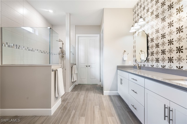 bathroom featuring vanity, wood-type flooring, and walk in shower