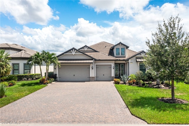 view of front facade featuring a front yard and a garage