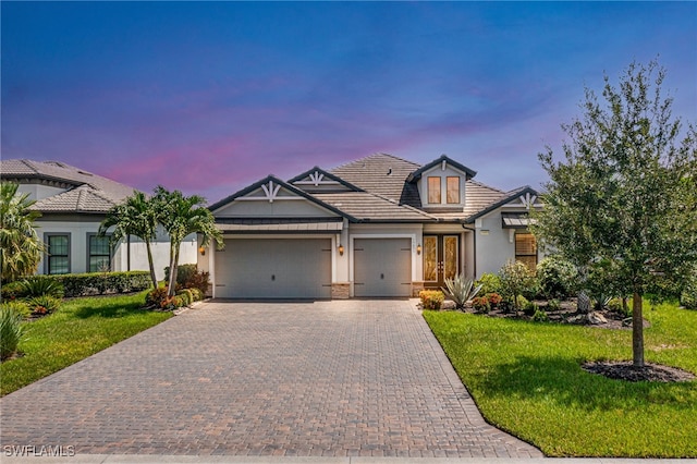 view of front of house with a yard and french doors