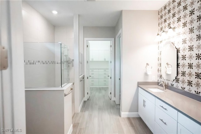 bathroom with vanity and a shower with shower door