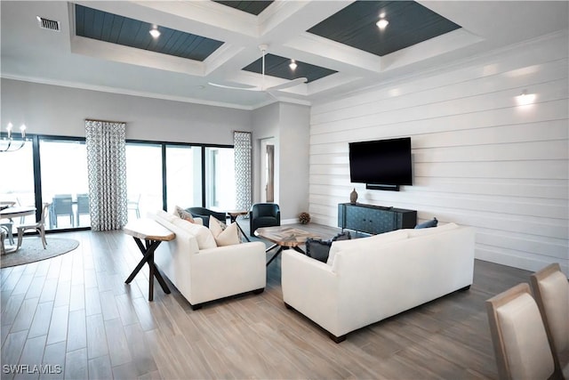 living room featuring coffered ceiling, hardwood / wood-style floors, and crown molding