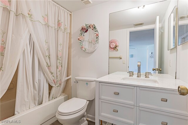 full bathroom with vanity, toilet, and shower / bath combo with shower curtain