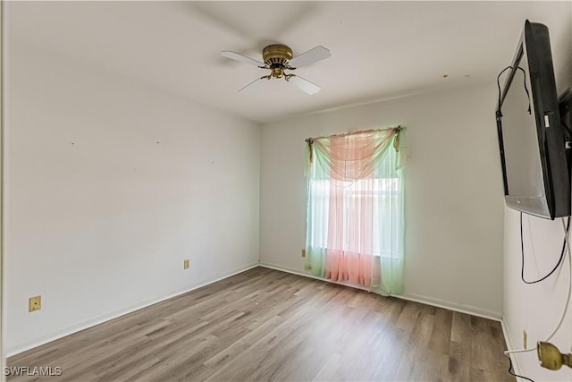 empty room with light hardwood / wood-style floors and ceiling fan