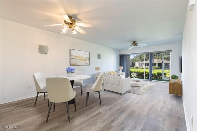 dining area featuring hardwood / wood-style flooring and ceiling fan