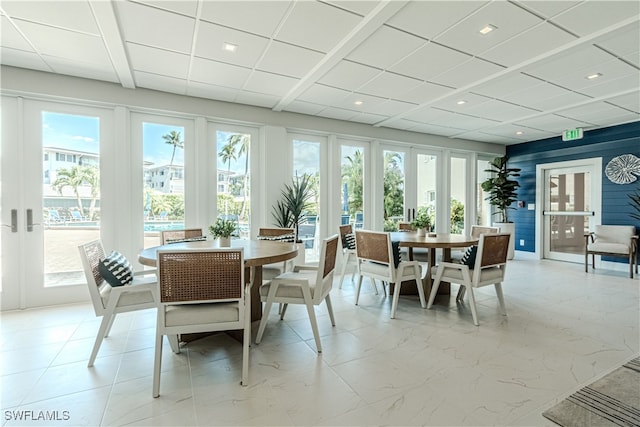 sunroom / solarium with a paneled ceiling and french doors