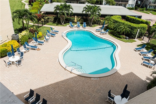 view of pool featuring central AC unit and a patio area