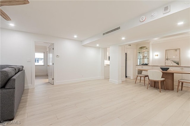 living room with light hardwood / wood-style flooring and ceiling fan