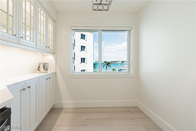 interior space featuring a water view and light hardwood / wood-style floors