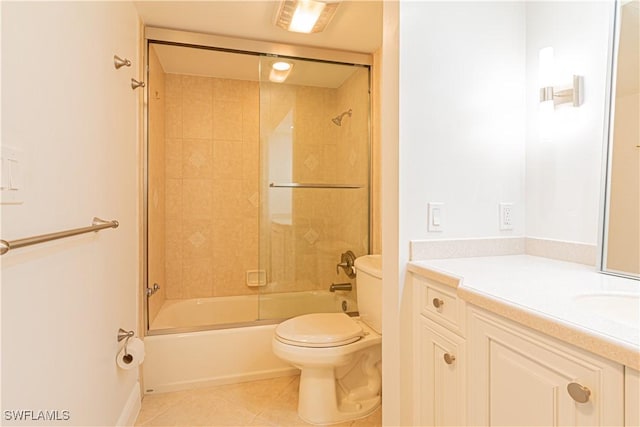 full bathroom featuring vanity, tile patterned flooring, combined bath / shower with glass door, and toilet