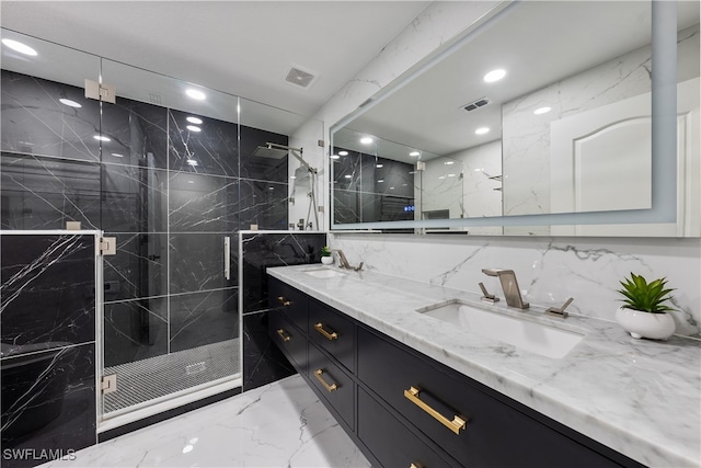 bathroom with vanity and a shower with shower door