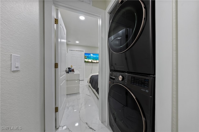 laundry area with stacked washer and dryer