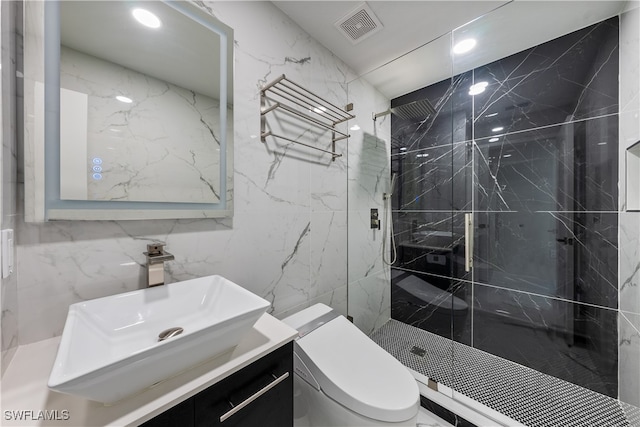 bathroom with vanity, toilet, tile walls, and a tile shower