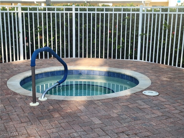 view of swimming pool with an in ground hot tub