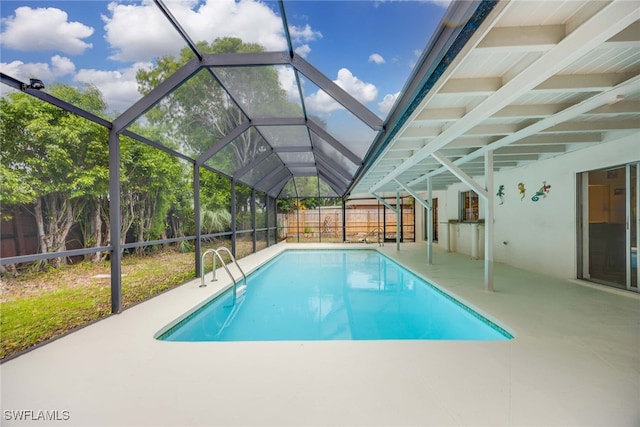 view of pool with a lanai and a patio