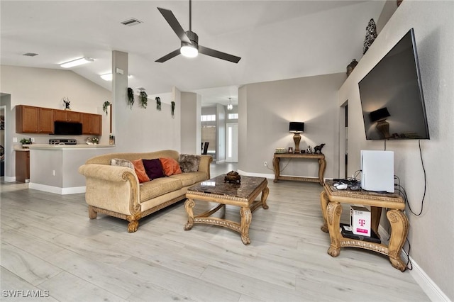 living room featuring ceiling fan and vaulted ceiling