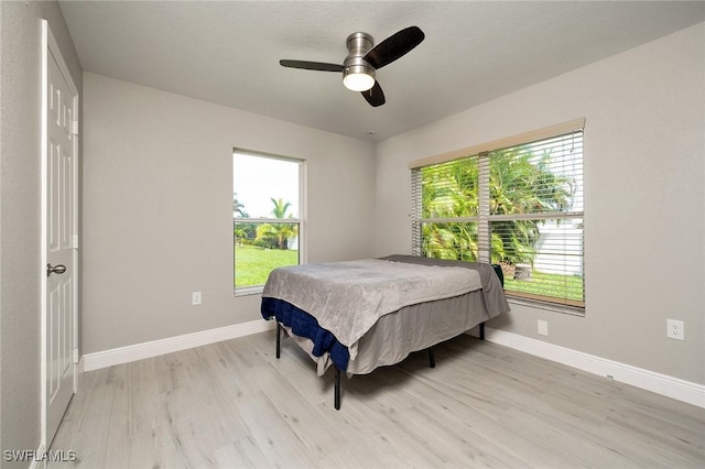 bedroom with light wood-type flooring and ceiling fan