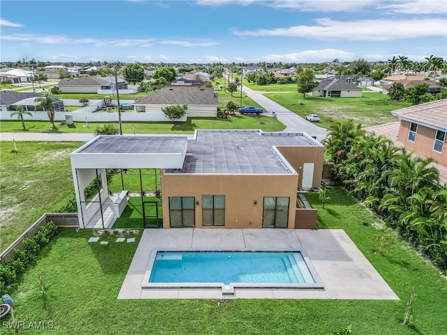 rear view of house with a patio and a yard