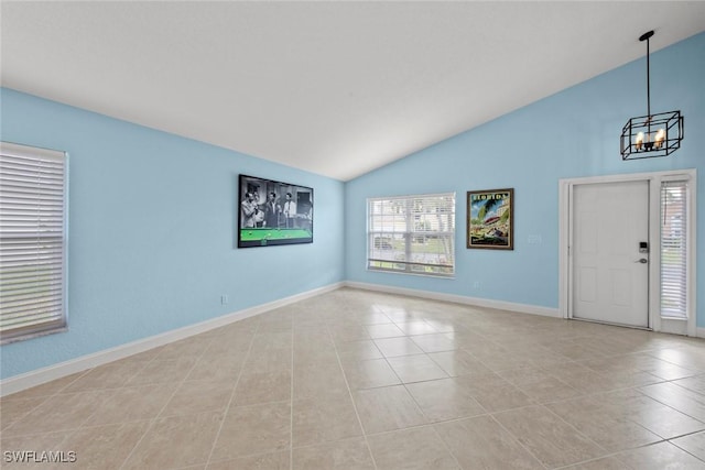 interior space featuring lofted ceiling, light tile patterned floors, and a notable chandelier