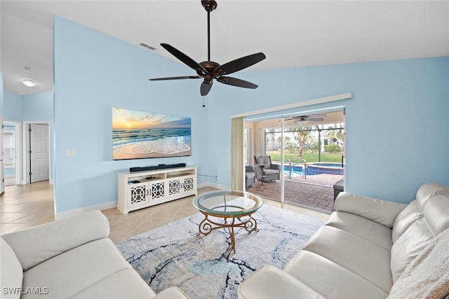 living room with lofted ceiling, light tile patterned floors, and ceiling fan