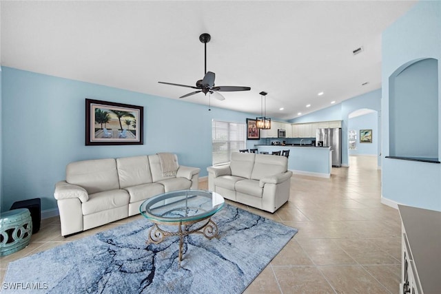 living room featuring light tile patterned floors, vaulted ceiling, and ceiling fan