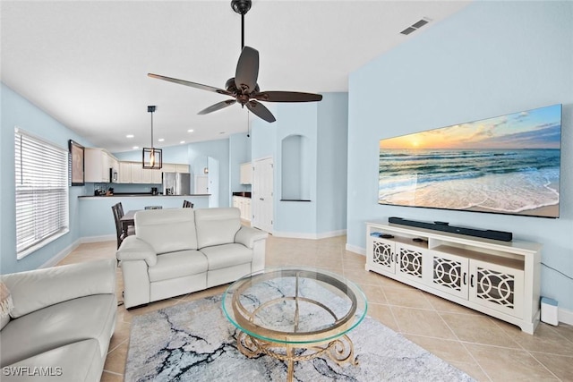 tiled living room with ceiling fan