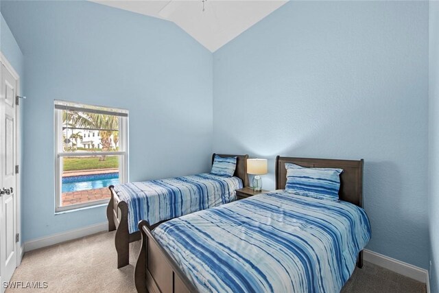 bedroom with light colored carpet and lofted ceiling