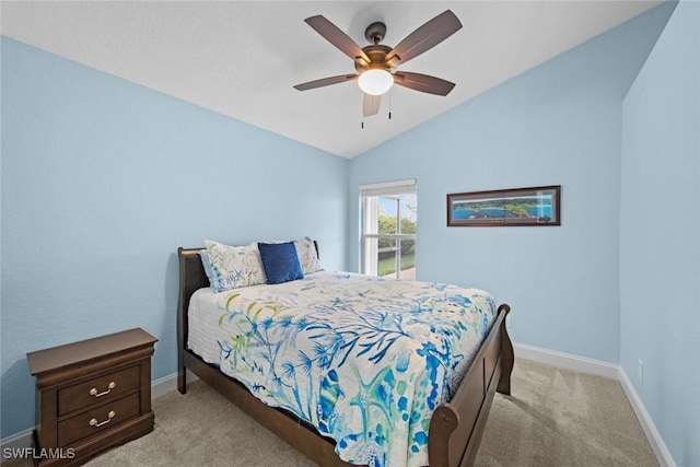 carpeted bedroom with ceiling fan and vaulted ceiling