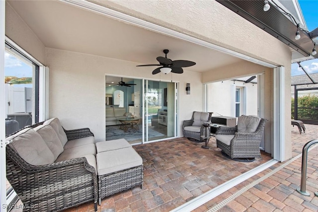 view of patio with outdoor lounge area and ceiling fan