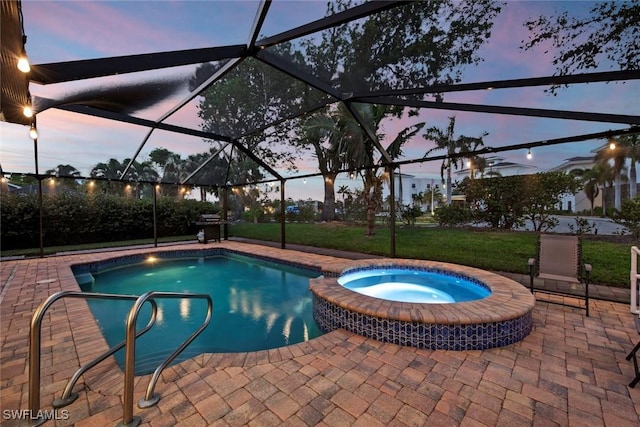 pool at dusk featuring a lanai, a patio area, a lawn, and an in ground hot tub