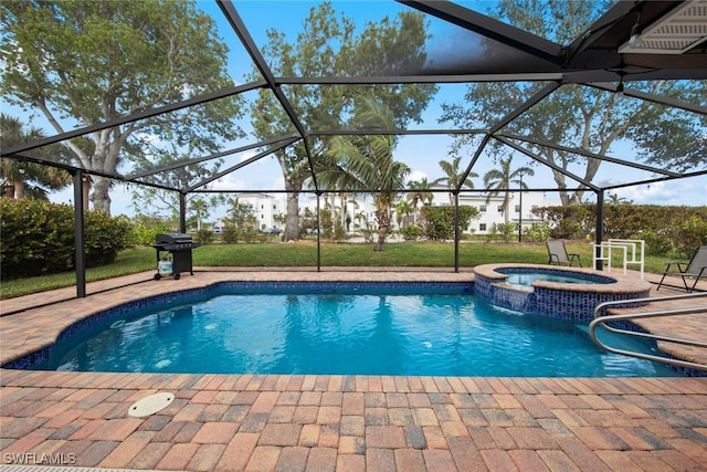 view of pool with grilling area, a patio, glass enclosure, and an in ground hot tub