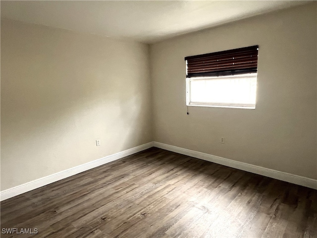 spare room featuring wood-type flooring