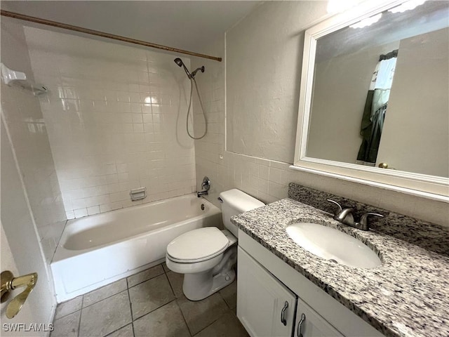 full bathroom featuring tile patterned floors, vanity, toilet, and tiled shower / bath