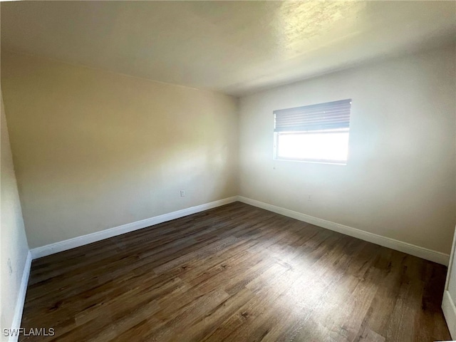 empty room featuring dark hardwood / wood-style floors