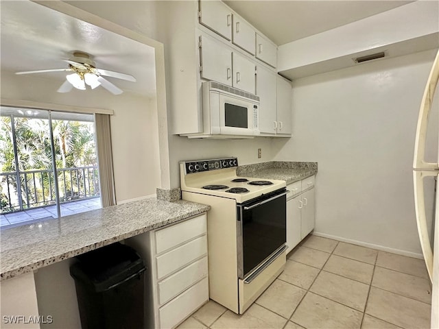 kitchen featuring ceiling fan, light tile patterned floors, white cabinets, and white appliances