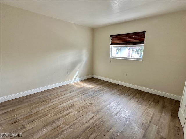 unfurnished room featuring hardwood / wood-style flooring